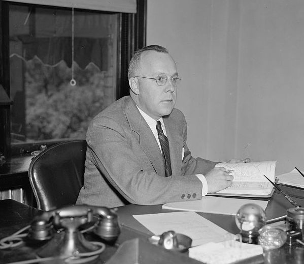 Frederick M. Babcock, shown here as Director of the Underwriting Division of the Federal Housing Administration in 1937, codified how the presence of “inharmonious” racial groups should be negatively factored into FHA mortgage applications. Photo digitized by Library of Congress.